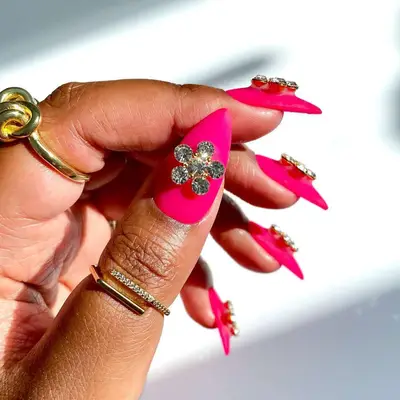 hot pink nails with floral gems
