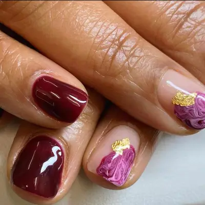 Black cherry nails with agate stone-inspired nail art.
