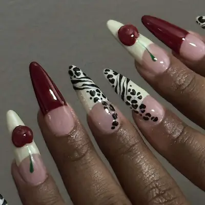 Black cherry manicure with cherries and animal print.