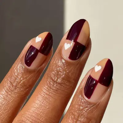 Checkered black cherry nails with white heart.