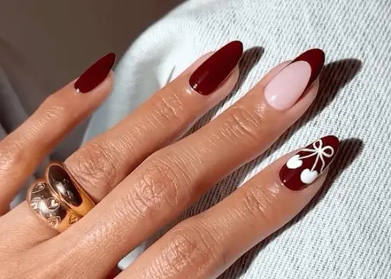 Black cherry nails with bow-cherry detail in white.