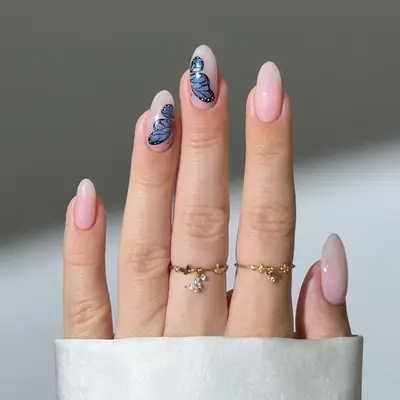 Bubble bath pink nails with a butterfly on the middle and ring fingers.