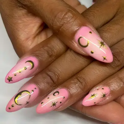 Bubble bath pink aura nails with moon and star gold embelishments.