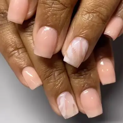 Glossy bubble bath pink nails with a marbling accent nail.