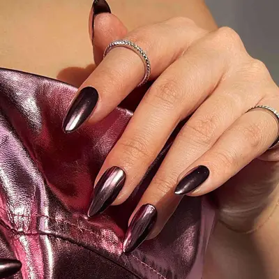 dark plum chrome polish on almond shaped nails