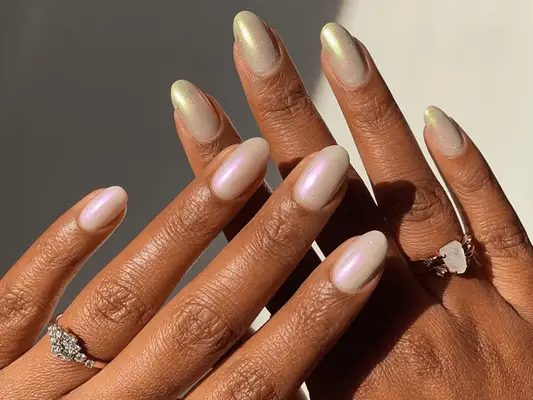 pearlescent shimmering chrome polish on pointed almond-shaped nails