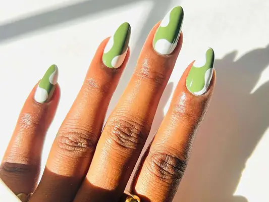 Green and white manicure in the sunlight