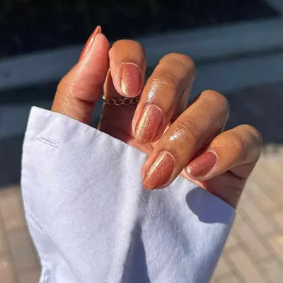 a short shimmery bronze manicure