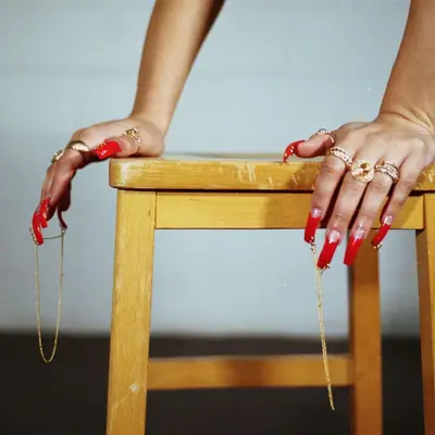 red half moon nails with long gold chains