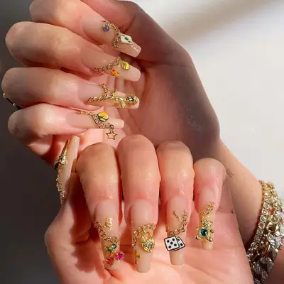 nude nails with chains and charms