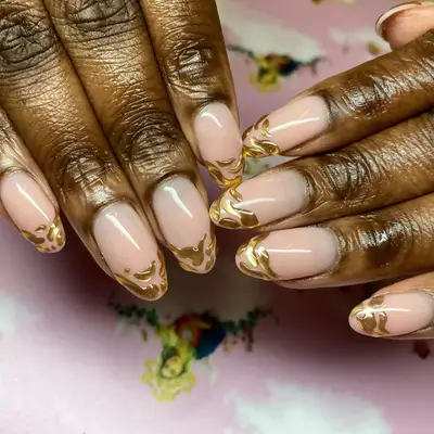 Manicure with gold chrome 3D wavy blob French tips