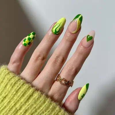 Green manicure with mix-and-match designs including checks, flame, wave, flower, and heart