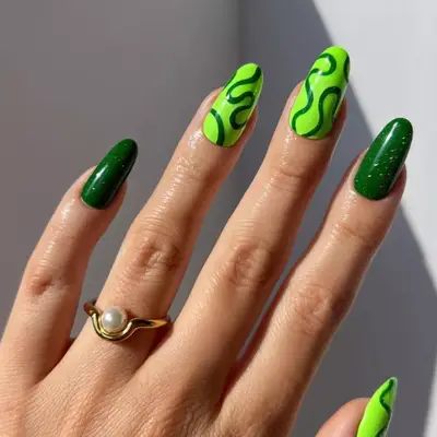 Manicure with lime green and dark glittery green squiggles