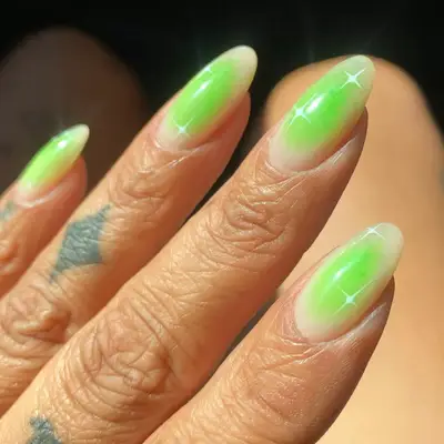 Manicure with green aura effect and white sparkle designs
