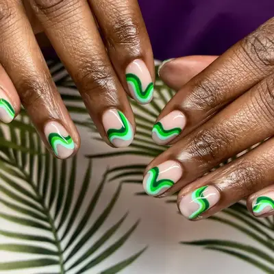 Manicure with neutral base and retro green swirl design