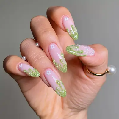 Manicure with neutral base and 3D green glitter drip tips