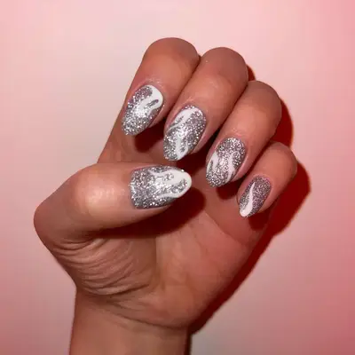 Silver glitter manicure with white flame designs