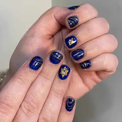 Dark blue manicure with gold Hanukkah-themed nail designs