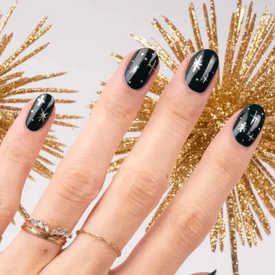 Manicure with black base and silver star designs