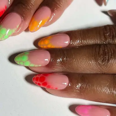 Hands with nail art featuring bright gradient designs and intricate patterns