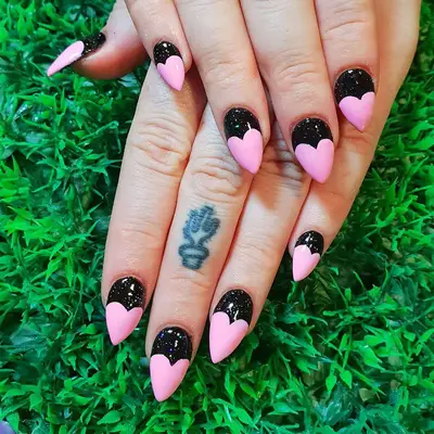 Black glitter nails with pink heart tips