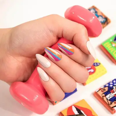 White almond manicure with colorful striped accent nails