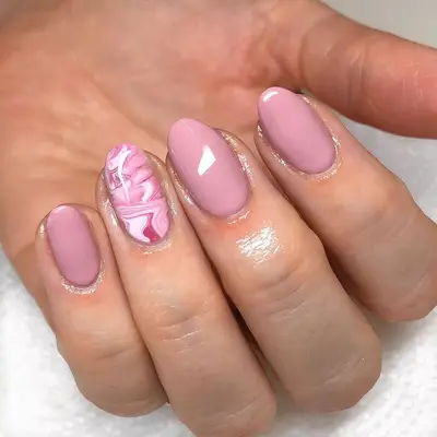 Pink manicure with marbled accent nail