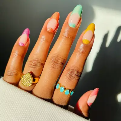 nails with negative space grids and orange nails with chrome accents