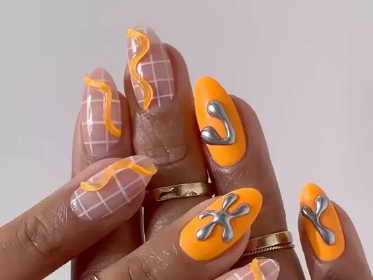 an orange negative space manicure with grid and builder gel designs