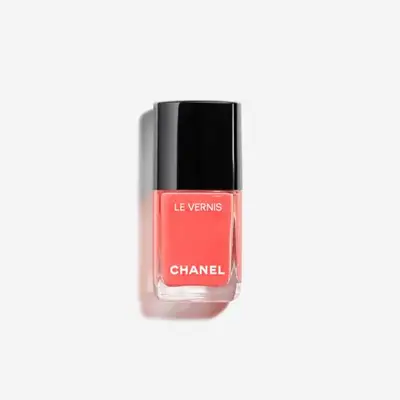 A bottle of Chanel Le Vernis nail polish with a black cap