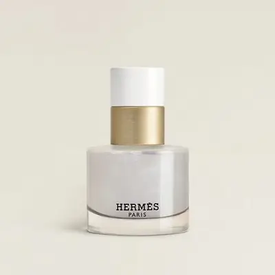 A bottle of Hermes Paris Blanc Orage perfume, simple design with a white and gold lid