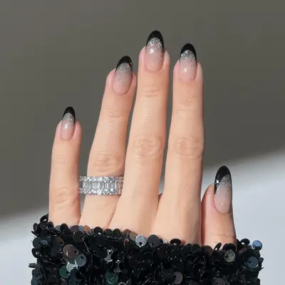 Black French nails with a glitter ombre fade.