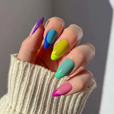 close up of nails with each one in different color and monochromatic french tips including purple, blue, yellow, green, pink