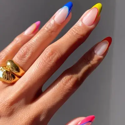 close up of nails with french tips in different colors including pink, blue, yellow, orange, pink