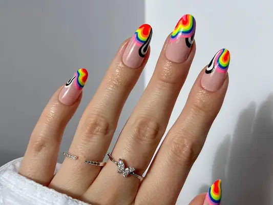 A French manicure with swirly rainbow tips