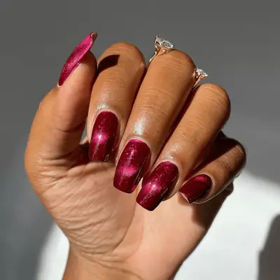 Square shaped burgundy nails with hints of pinks