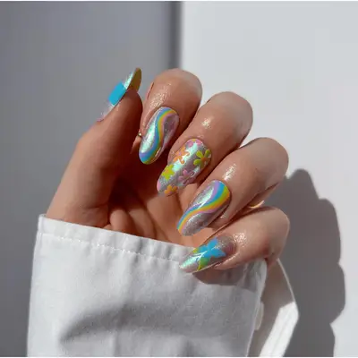 metallic glittery flower and swirl art on mid-length nails