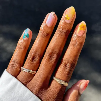 glittery surfer-inspired mismatch nail art with tropical flowers