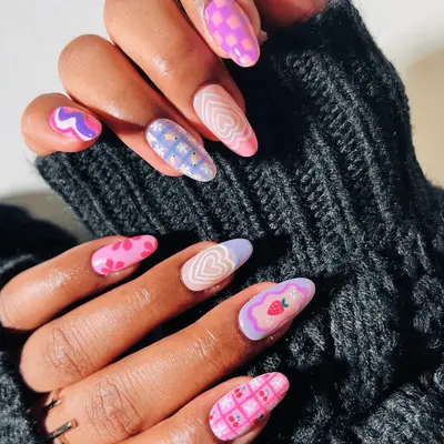 intricate mismatch checkered heart fruit and flower designs on rounded mid-length nails