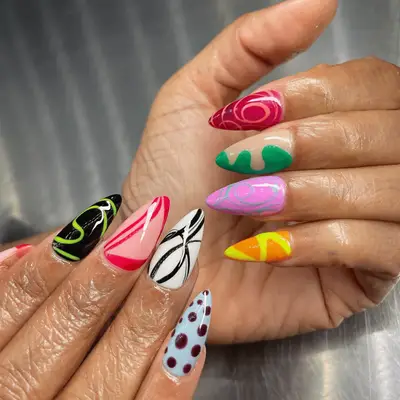 mismatch abstract nails with line art and polka dots on pointed nails