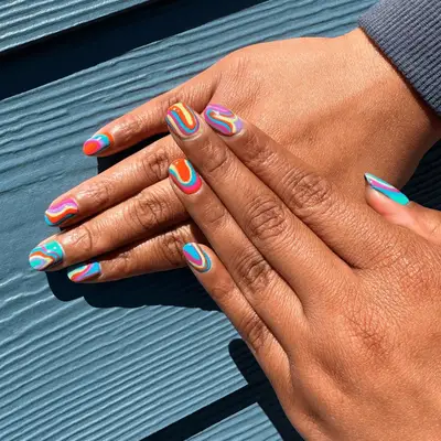 varicolored swirl designs on short natural nails