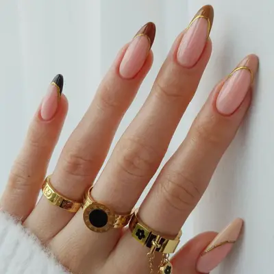 French manicure with neutral gradient tips and gold dividing outline