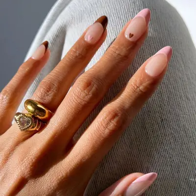 French manicure with brown and pink tips and small heart designs