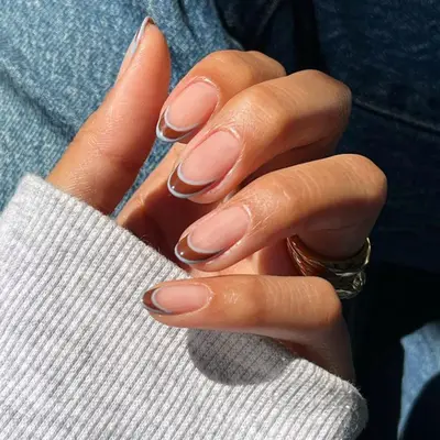 Brown French tip manicure with baby blue outlines