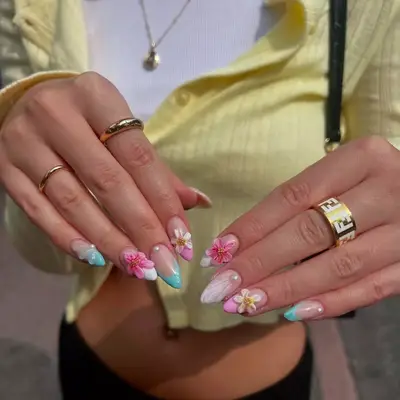 Manicure with flower nail art and blue French tips