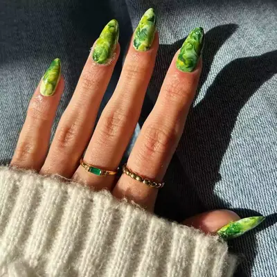 Long almond nails with green marble design