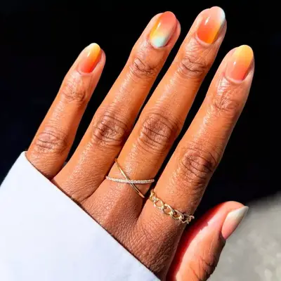 close up of minimal manicure with neon yellow designs on white background