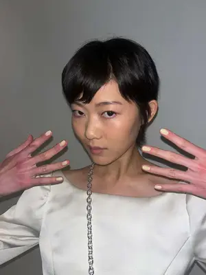 Model with butter yellow nails