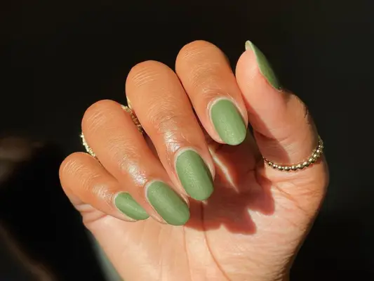 A sage green manicure with a matte finish