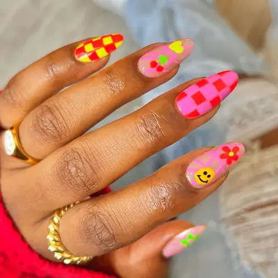 Psychedelic picnic nails with checkerboard prints and florals in neon colors.